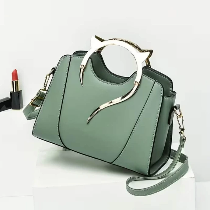 Sage green structured tote bag with a unique silver cat-ear shaped handle