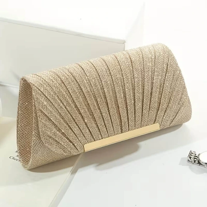 Elegant champagne gold evening clutch with fan-pleated detailing and a sleek gold-tone metallic bar accent, perfect for formal events.