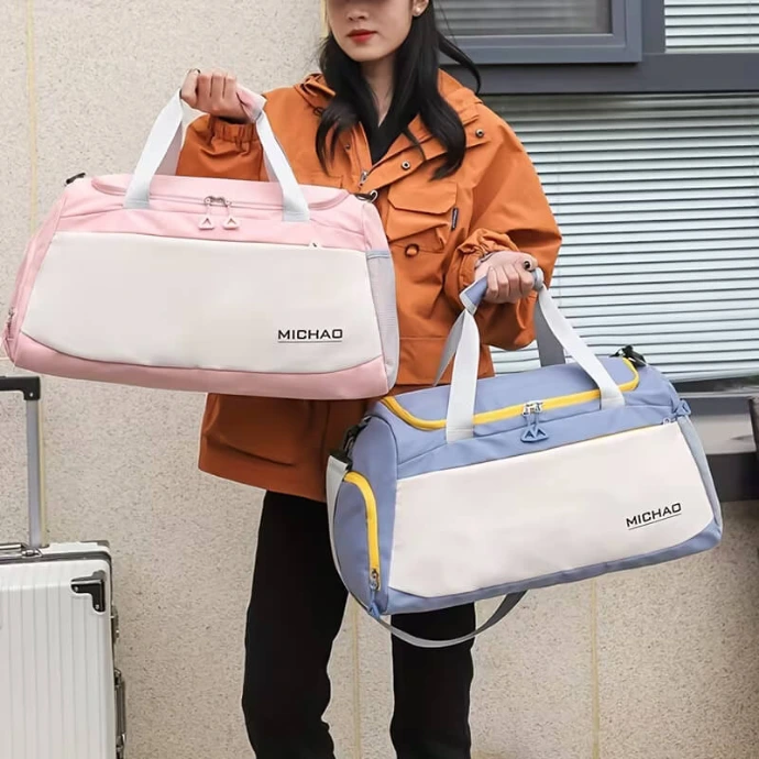 Sporty travel duffle bags in soft pink and blue, featuring a spacious design and lightweight material, perfect for gym or weekend trips.