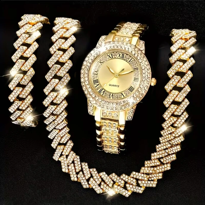 A luxury gold-tone women's watch and matching jewelry set encrusted with sparkling rhinestones on a black background.