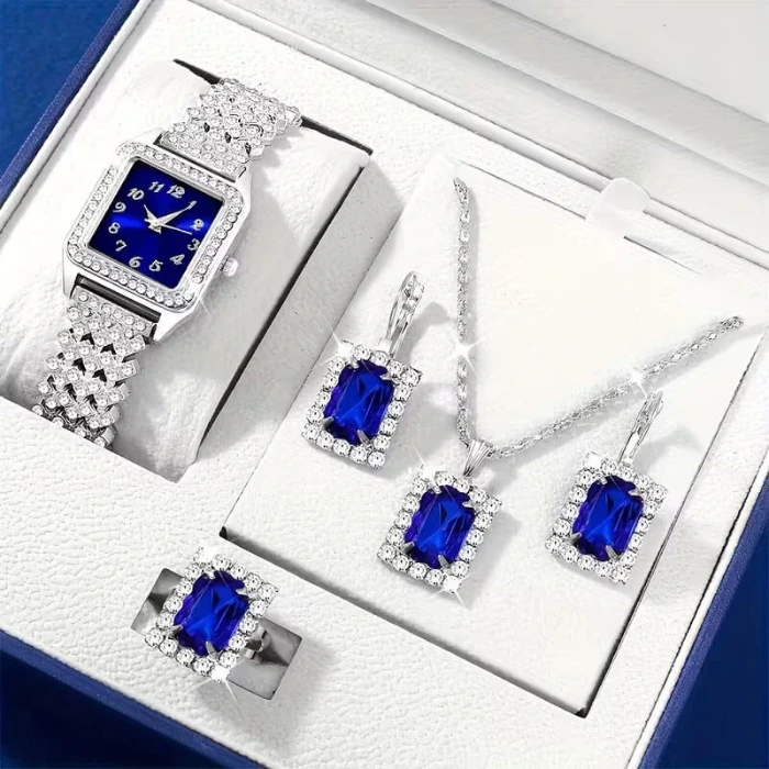 Silver and deep blue jewelry set in a white gift box, featuring a crystal-embellished watch, necklace, drop earrings, and a matching ring.